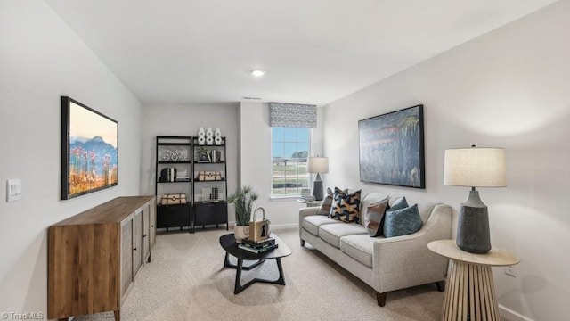 living area with light carpet and baseboards