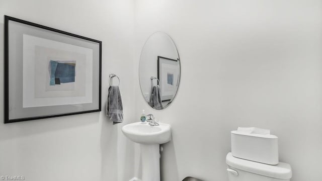 half bathroom featuring toilet