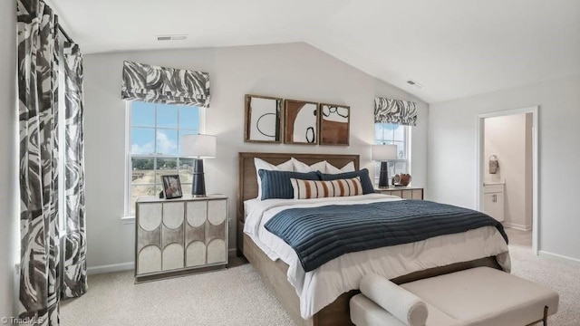 bedroom featuring baseboards, ensuite bath, visible vents, and vaulted ceiling