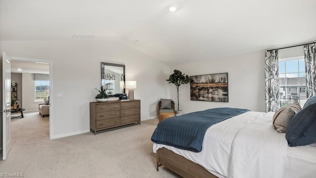 carpeted bedroom featuring baseboards and lofted ceiling