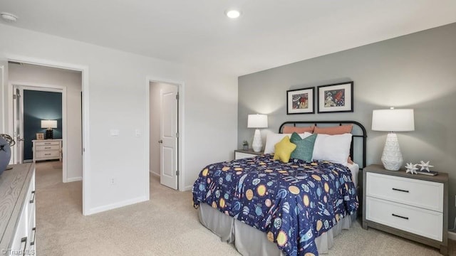 bedroom featuring baseboards and light colored carpet
