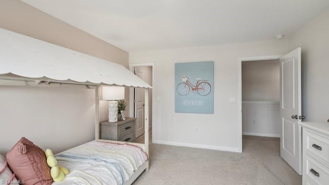 bedroom featuring baseboards and light colored carpet