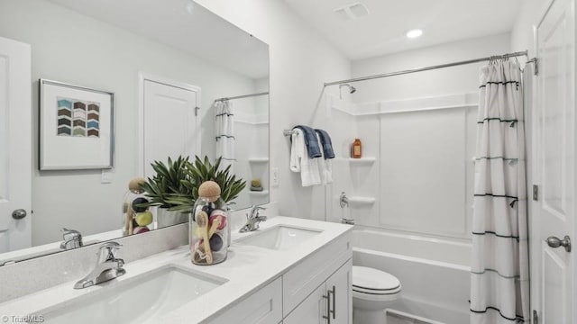 full bathroom with shower / bath combo with shower curtain, a sink, toilet, and double vanity