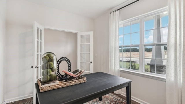 office space with baseboards and french doors