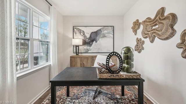 office space with baseboards and wood finished floors