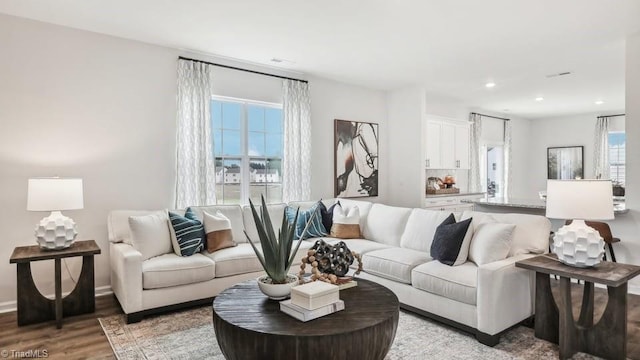living area featuring light wood-style floors and recessed lighting
