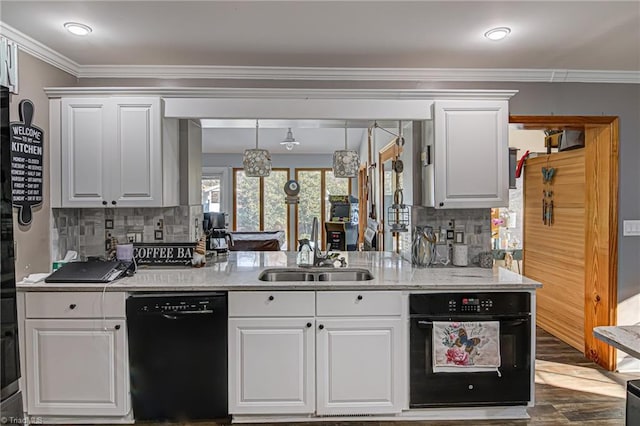 kitchen featuring black dishwasher, tasteful backsplash, white cabinetry, and sink