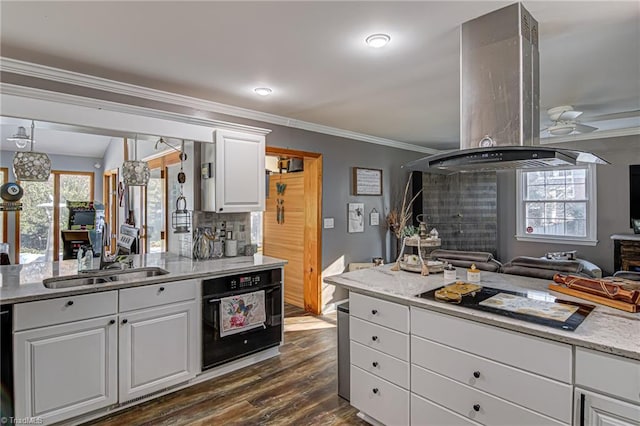 kitchen with a wealth of natural light, white cabinetry, black appliances, and dark hardwood / wood-style floors