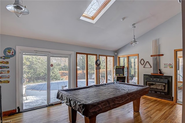 recreation room featuring lofted ceiling with skylight, light hardwood / wood-style flooring, and billiards