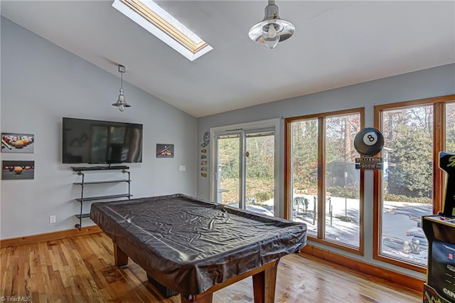 recreation room with hardwood / wood-style flooring, billiards, a healthy amount of sunlight, and vaulted ceiling with skylight