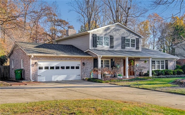 view of front of home with a front yard and a garage