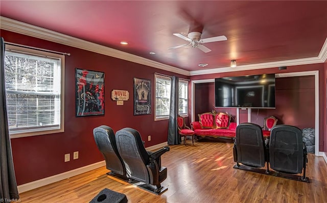 cinema featuring hardwood / wood-style floors, ceiling fan, and ornamental molding