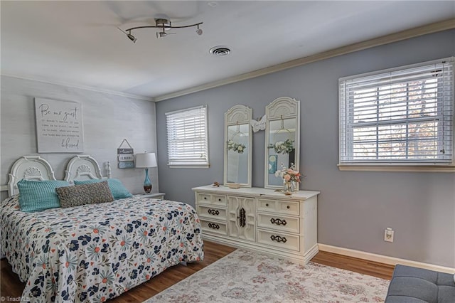 bedroom with dark hardwood / wood-style flooring, multiple windows, and crown molding