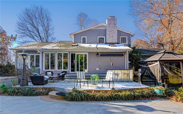 back of property featuring an outdoor living space and a patio