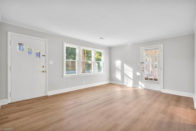 foyer featuring wood finished floors and baseboards