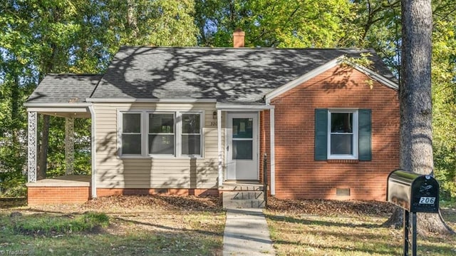 bungalow featuring brick siding, crawl space, a chimney, and a shingled roof