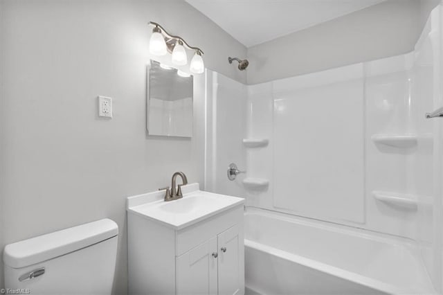 bathroom featuring bathtub / shower combination, vanity, and toilet