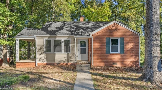 view of front of home featuring a shingled roof, crawl space, brick siding, and a chimney