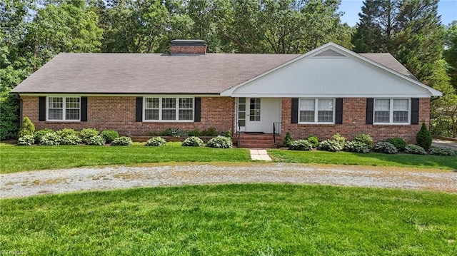 1732 Edgewood Ave, Burlington, NC 27215 - ranch-style house with brick siding, a chimney, a front lawn, and view of wooded area