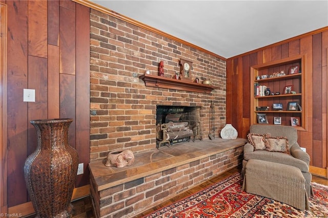 1732 Edgewood Ave, Burlington, NC 27215 - living room featuring wooden walls, ornamental molding, built in shelves, and a fireplace