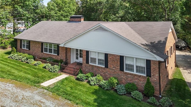 1732 Edgewood Ave, Burlington, NC 27215 - view of front of home featuring brick siding, a chimney, a front lawn, and a shingled roof