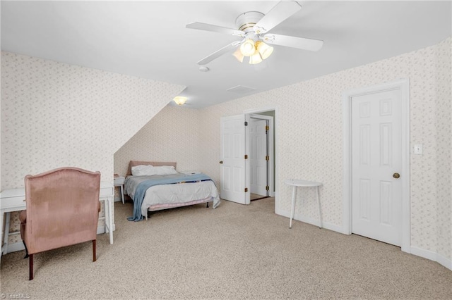 bedroom with a ceiling fan, carpet flooring, and wallpapered walls