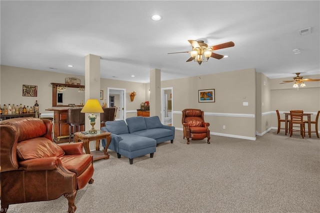 living room featuring recessed lighting, light colored carpet, ceiling fan, visible vents, and a dry bar