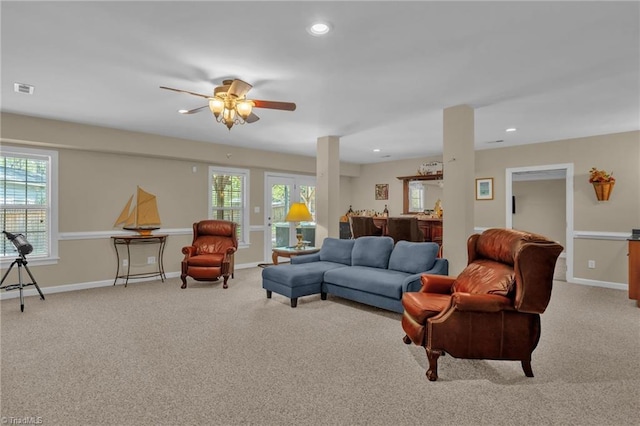 living area with plenty of natural light, carpet flooring, and baseboards