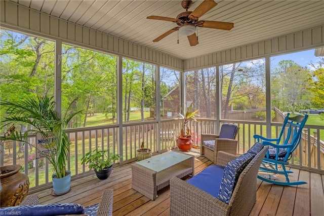 sunroom with an outdoor living space and a ceiling fan