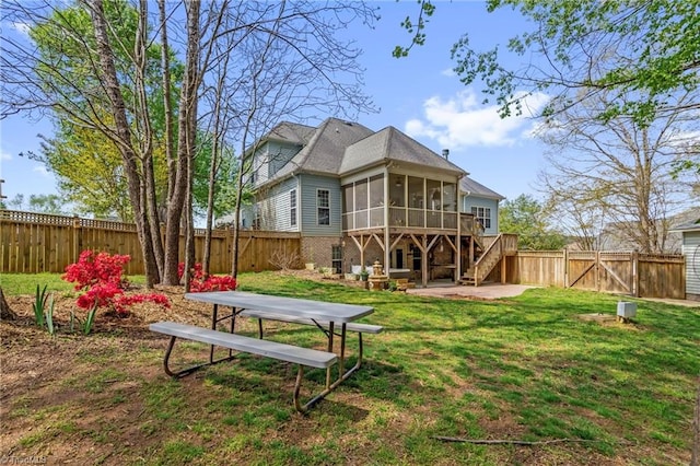 back of house featuring a fenced backyard, a gate, a patio, a sunroom, and stairs