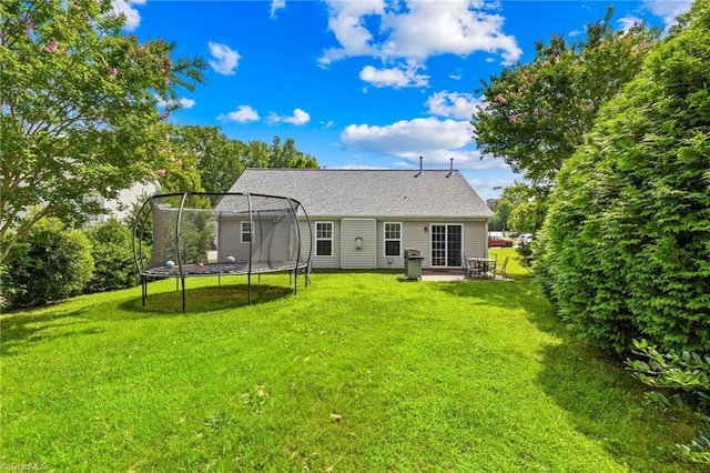 5803 Sycamore Glen Rd, Greensboro, NC 27405 - back of property featuring a trampoline, a lawn, and a patio