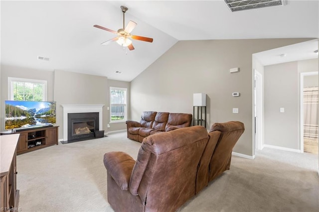 5803 Sycamore Glen Rd, Greensboro, NC 27405 - living area with light carpet, a ceiling fan, vaulted ceiling, healthy amount of natural light, and a glass covered fireplace