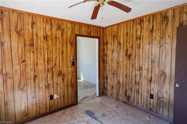 spare room featuring wood walls and ceiling fan