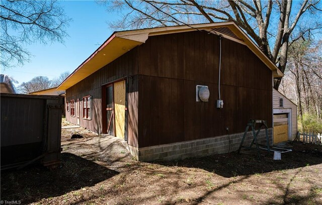 view of property exterior with an outbuilding