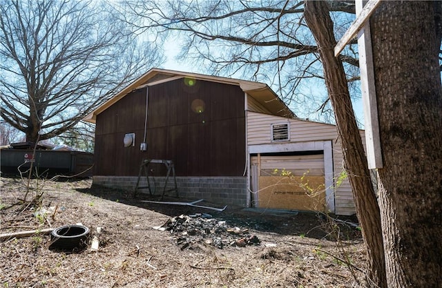 view of outbuilding featuring a garage and an outbuilding