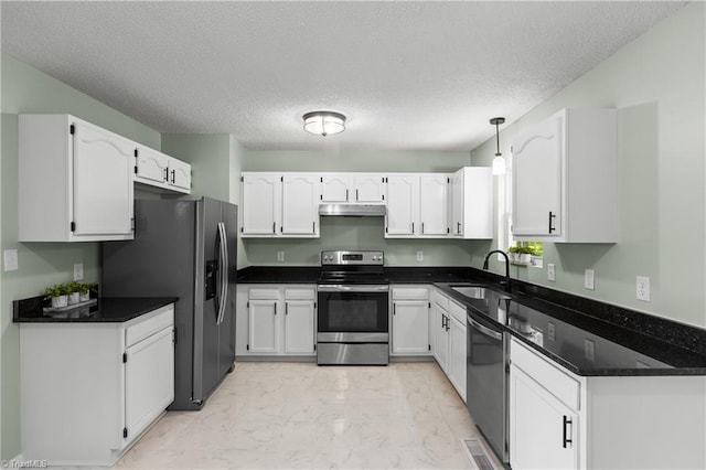 1650 Billy Dr, Winston-Salem, NC 27107 - kitchen with appliances with stainless steel finishes, light marble finish flooring, white cabinets, under cabinet range hood, and a textured ceiling