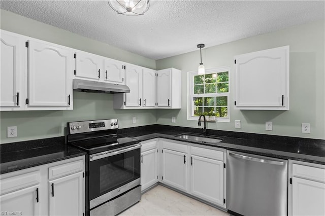 1650 Billy Dr, Winston-Salem, NC 27107 - kitchen with stainless steel appliances, under cabinet range hood, white cabinetry, a textured ceiling, and pendant lighting