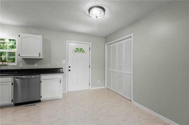 1650 Billy Dr, Winston-Salem, NC 27107 - kitchen with stainless steel dishwasher, a textured ceiling, white cabinets, light marble finish flooring, and dark countertops