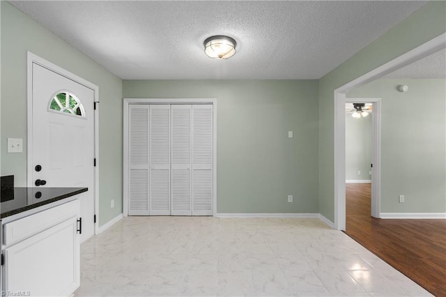 1650 Billy Dr, Winston-Salem, NC 27107 - unfurnished dining area with light marble finish flooring, a textured ceiling, and a ceiling fan