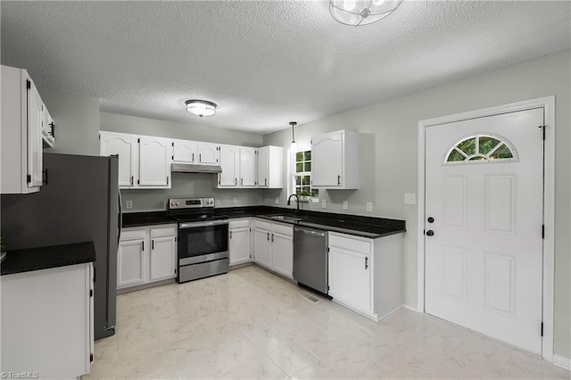 1650 Billy Dr, Winston-Salem, NC 27107 - kitchen featuring appliances with stainless steel finishes, healthy amount of natural light, dark countertops, and a textured ceiling