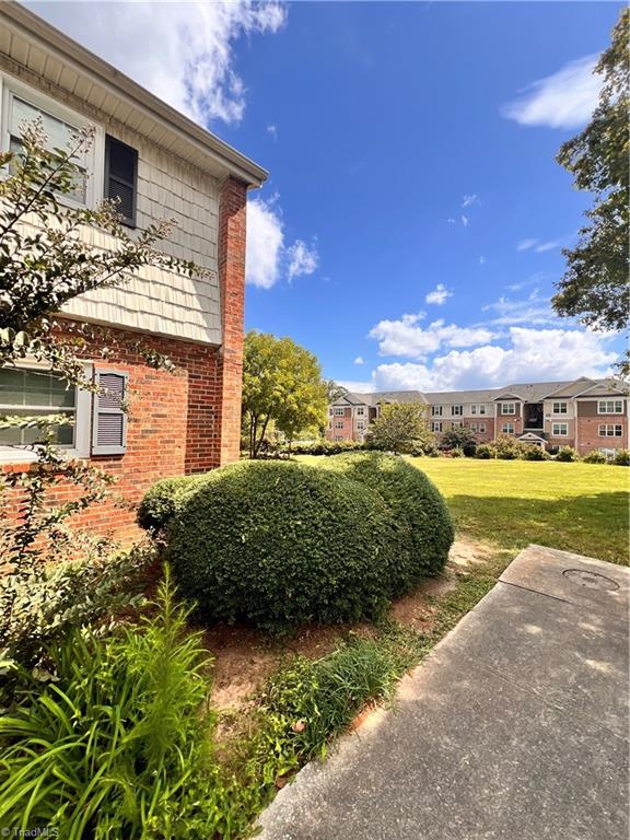 view of side of home with a lawn