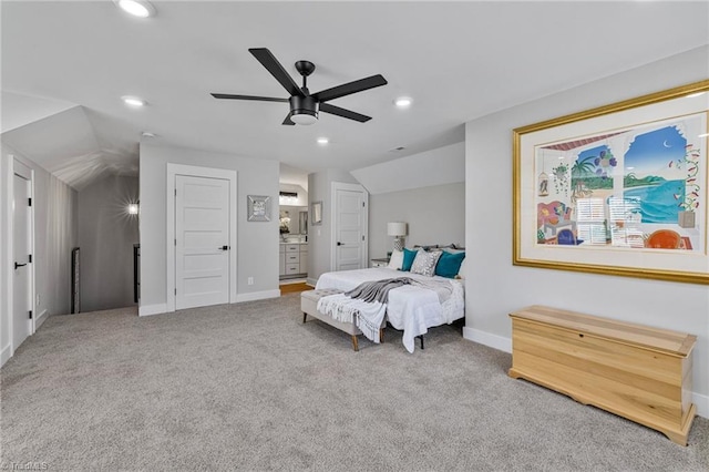 bedroom featuring lofted ceiling, ensuite bath, ceiling fan, and carpet flooring