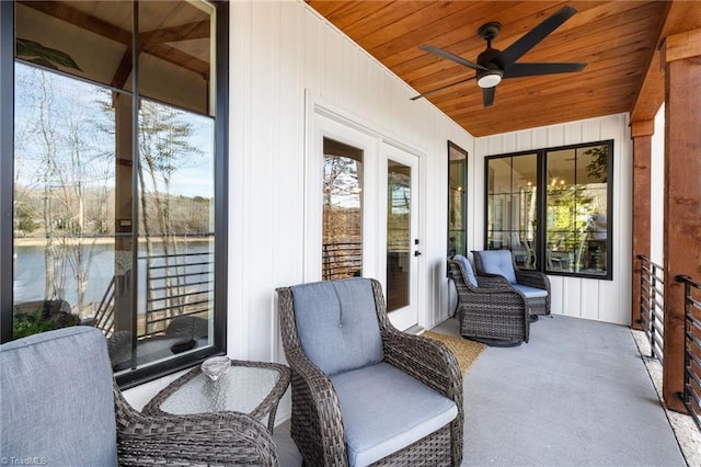 sunroom / solarium featuring wood ceiling, ceiling fan, and a healthy amount of sunlight