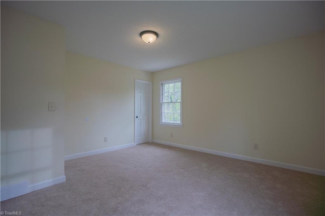 804 W 4th Ave, Lexington, NC 27292 - spare room with baseboards and light colored carpet