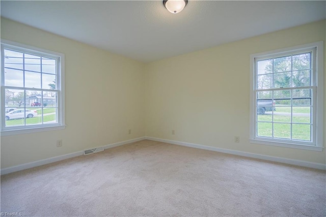 804 W 4th Ave, Lexington, NC 27292 - empty room with plenty of natural light, light colored carpet, and visible vents