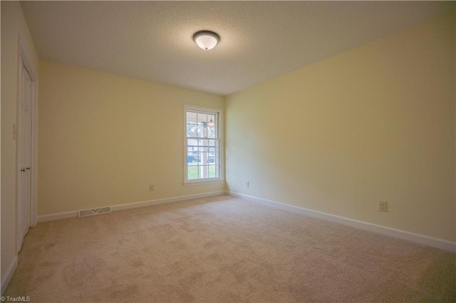 804 W 4th Ave, Lexington, NC 27292 - unfurnished room featuring light carpet, a textured ceiling, baseboards, and visible vents