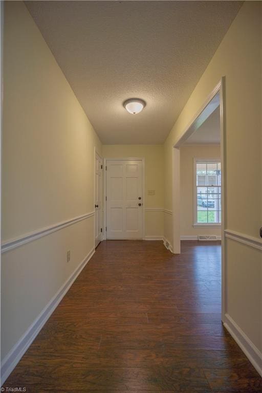 804 W 4th Ave, Lexington, NC 27292 - corridor with dark wood-style floors, baseboards, and a textured ceiling