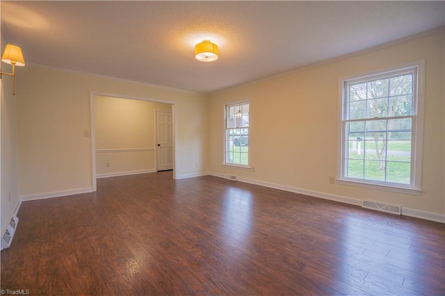 804 W 4th Ave, Lexington, NC 27292 - empty room with a wealth of natural light, visible vents, crown molding, and dark wood-style flooring