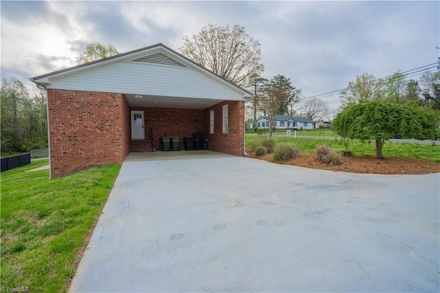 804 W 4th Ave, Lexington, NC 27292 - view of home's exterior with driveway, brick siding, a lawn, and a carport