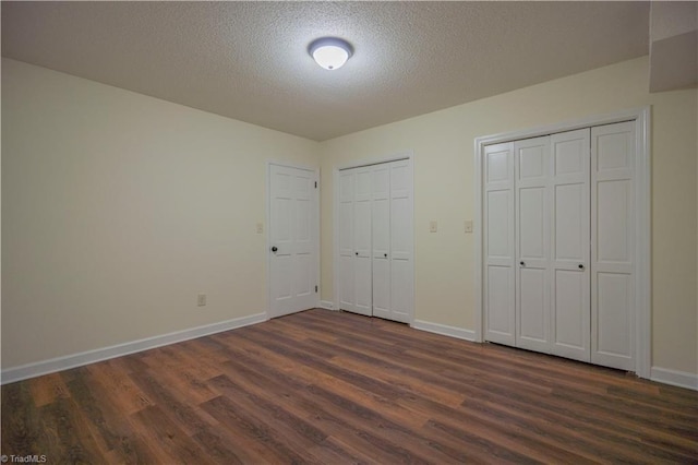 804 W 4th Ave, Lexington, NC 27292 - unfurnished bedroom featuring baseboards, multiple closets, and dark wood finished floors